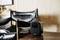 A small, square speaker sits on a table next to a black leather armchair in a modern room.