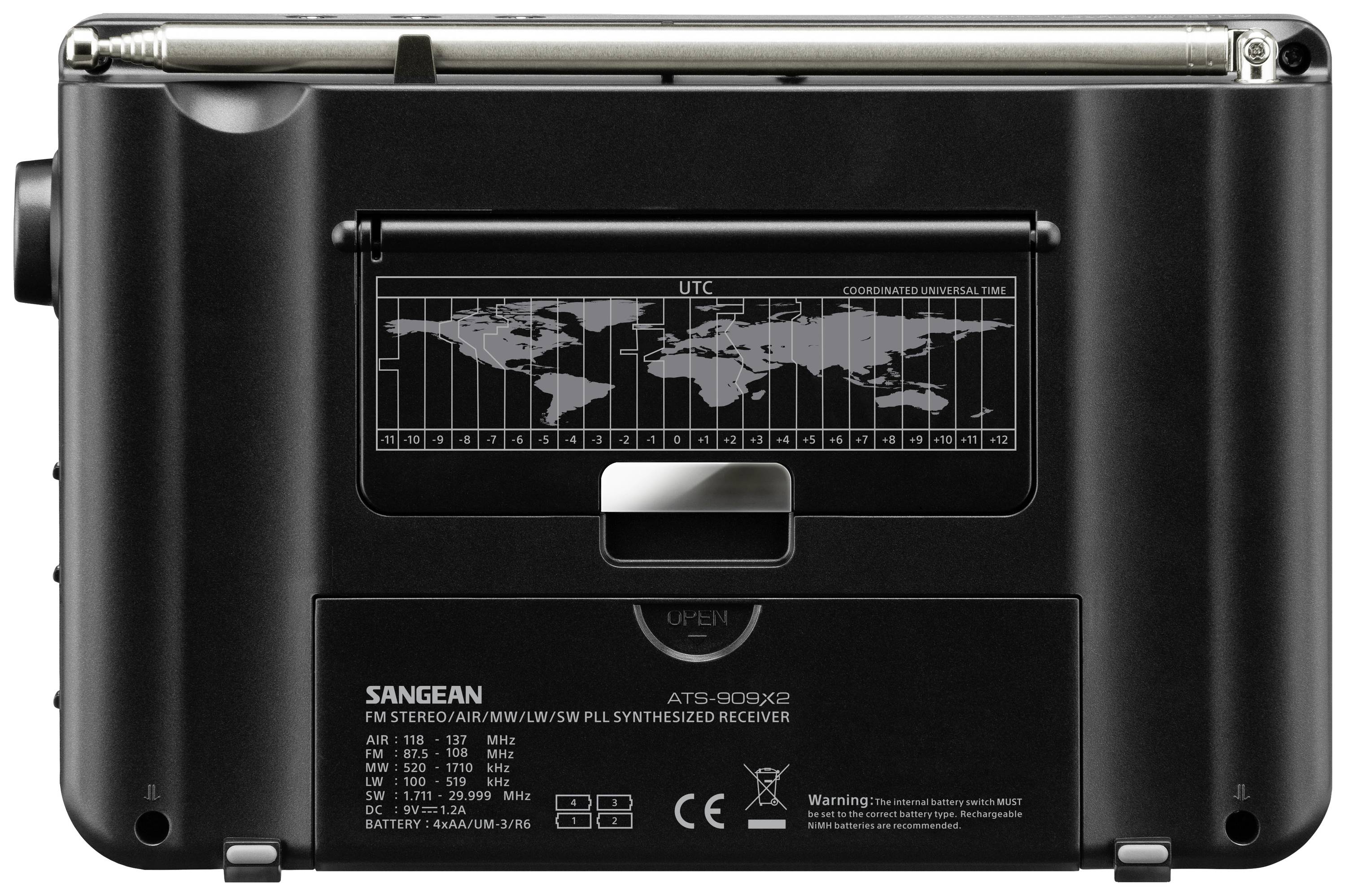 Back of a portable radio with a world map and time zone table. Shows various reception frequencies and manufacturer information.