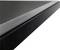 Close-up of a glossy black table edge at an angled perspective. Minimalist, modern design.