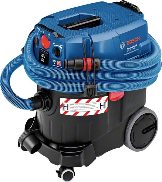 A blue and black industrial vacuum cleaner with wheels, a large casing and a coiled hose. Control panels are located on the front side.