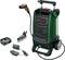 A portable pressure washer with accessories: a spray gun, a battery, a charger, and a brush. Brand logo visible.