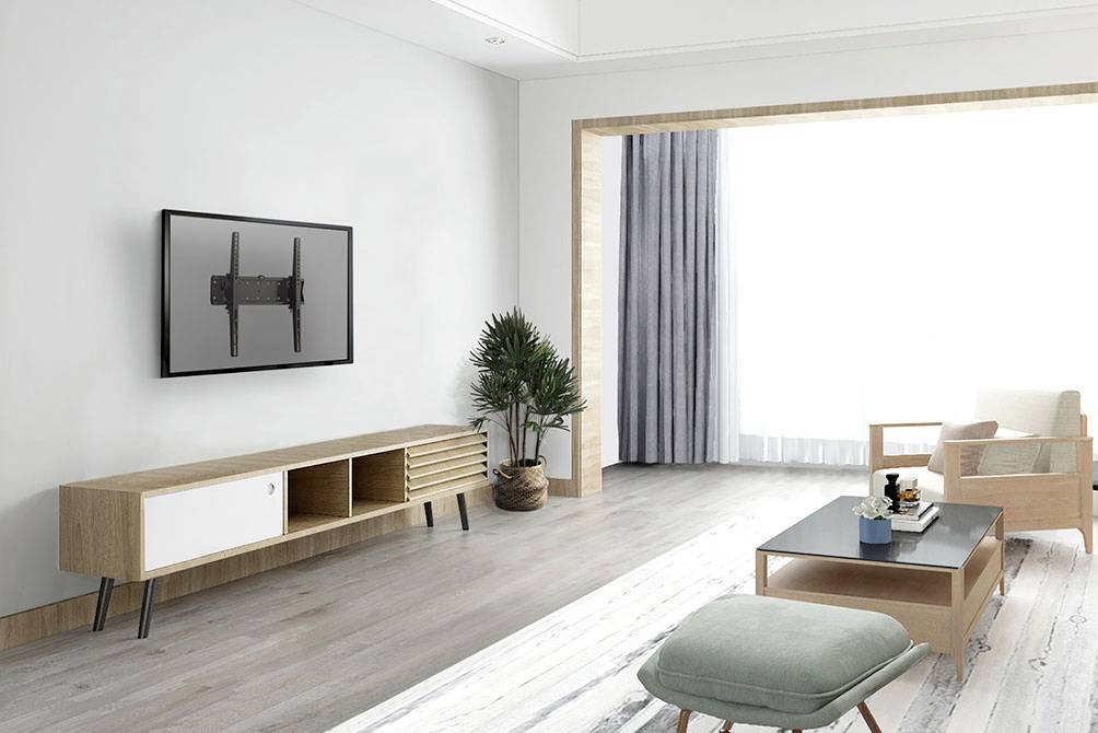 Bright, modern living room with wooden furniture, television mounted on the wall, large windows and plants in the corner. A calm and minimalist design.