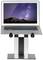 A laptop sits on an adjustable height, silver laptop stand. The screen displays a night sky over mountains.