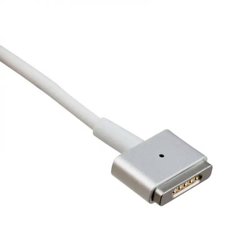 White magnetic laptop charging cable with rectangular, flat plug and gold contacts, isolated against a white background.