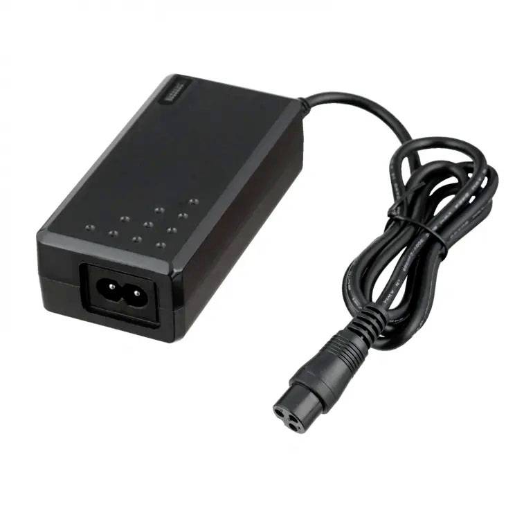 Black laptop charger with power cable. Rectangular shape with two slots for power connection.