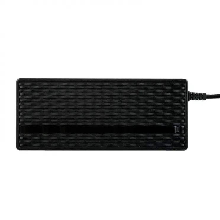 Black external hard drive with a textured surface and an attached cable on a white background.