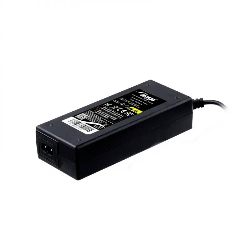 Black power supply with C13 power cord, technical specifications and safety warnings printed on the top surface.