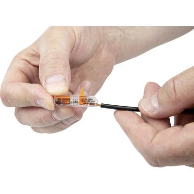 Two hands connect a black cable with an open transparent cable connector.
