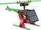 A colourful model helicopter made from plastic components, featuring a solar panel on its side to provide electrical power.