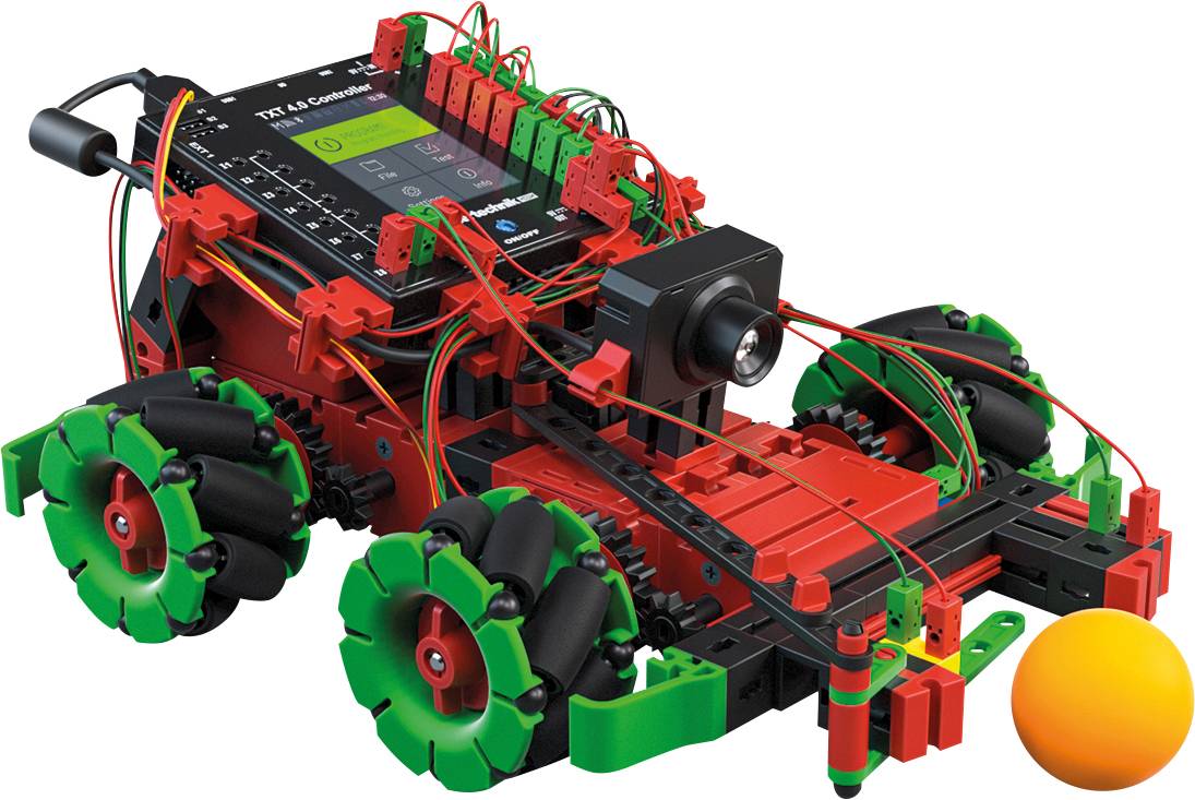 A red and green robot car with distinctive wheels and a camera is driving towards an orange ball.