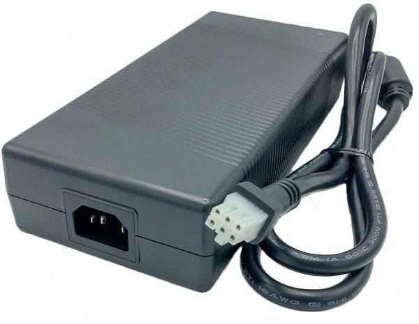 Black power supply with a detachable power cable, three-pin plug, and a ventilation opening, suitable for electronic devices.
