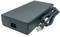 A black power supply with a three-pin plug and a mains cable. It is used to power electronic devices.