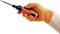 A hand wearing an orange glove is holding a red electric tool with a long tip, ready for use.