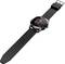 A black smartwatch with a round display shows the time and heart rate. The watch has a robust design and an adjustable strap.