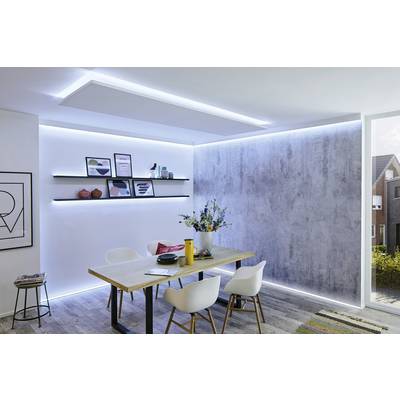 Dining room with a wooden table, surrounded by white chairs. Shelves with decorations are mounted on the wall. Room in a modern style with indirect lighting.
