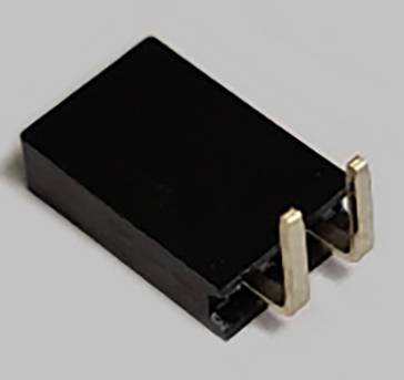 A black shorting link with two metal pins is shown. It is used for connecting contacts on a circuit board.