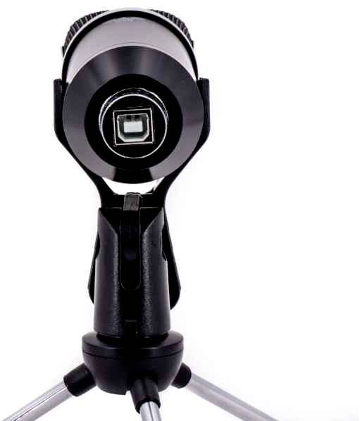 A black telescope is mounted on a silver tripod, positioned pointing upwards.