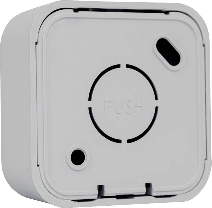 A square, white plastic device with the inscription 'PUSH', a circular symbol, and an oval opening.