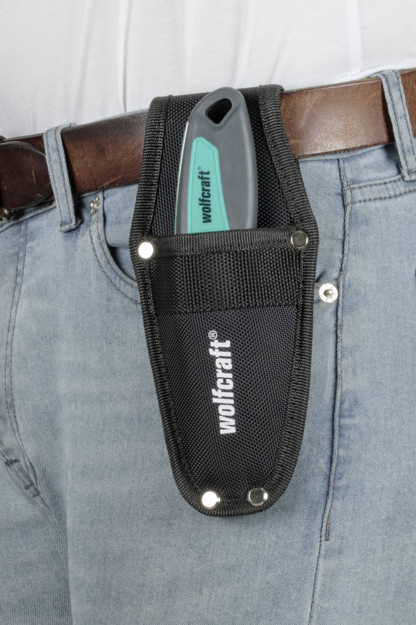 A knife in a holster worn on a belt, with the inscription 'wolfcraft' on the holster.