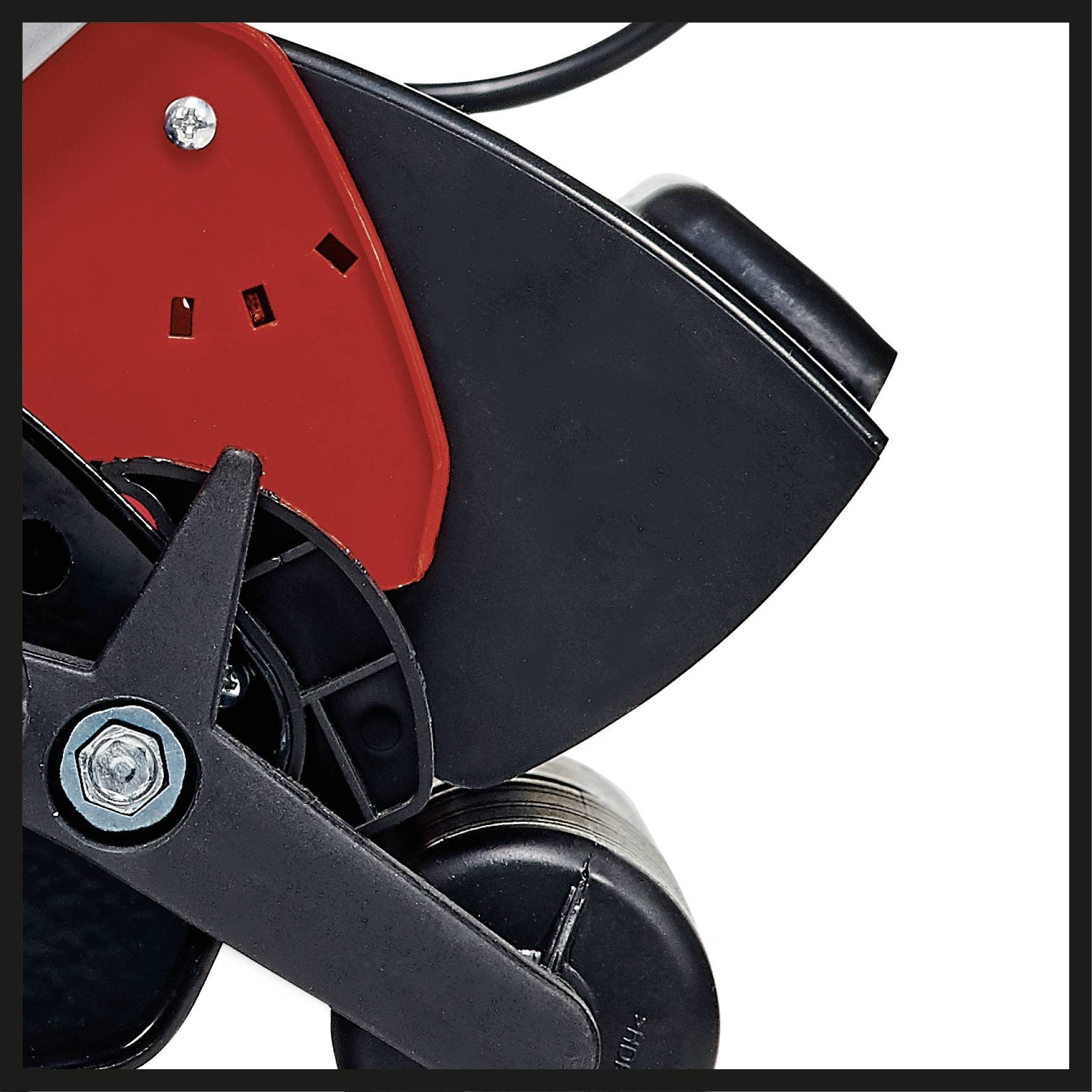 A close-up of part of a machine with a red and black component. A metal bolt and a cable are visible.