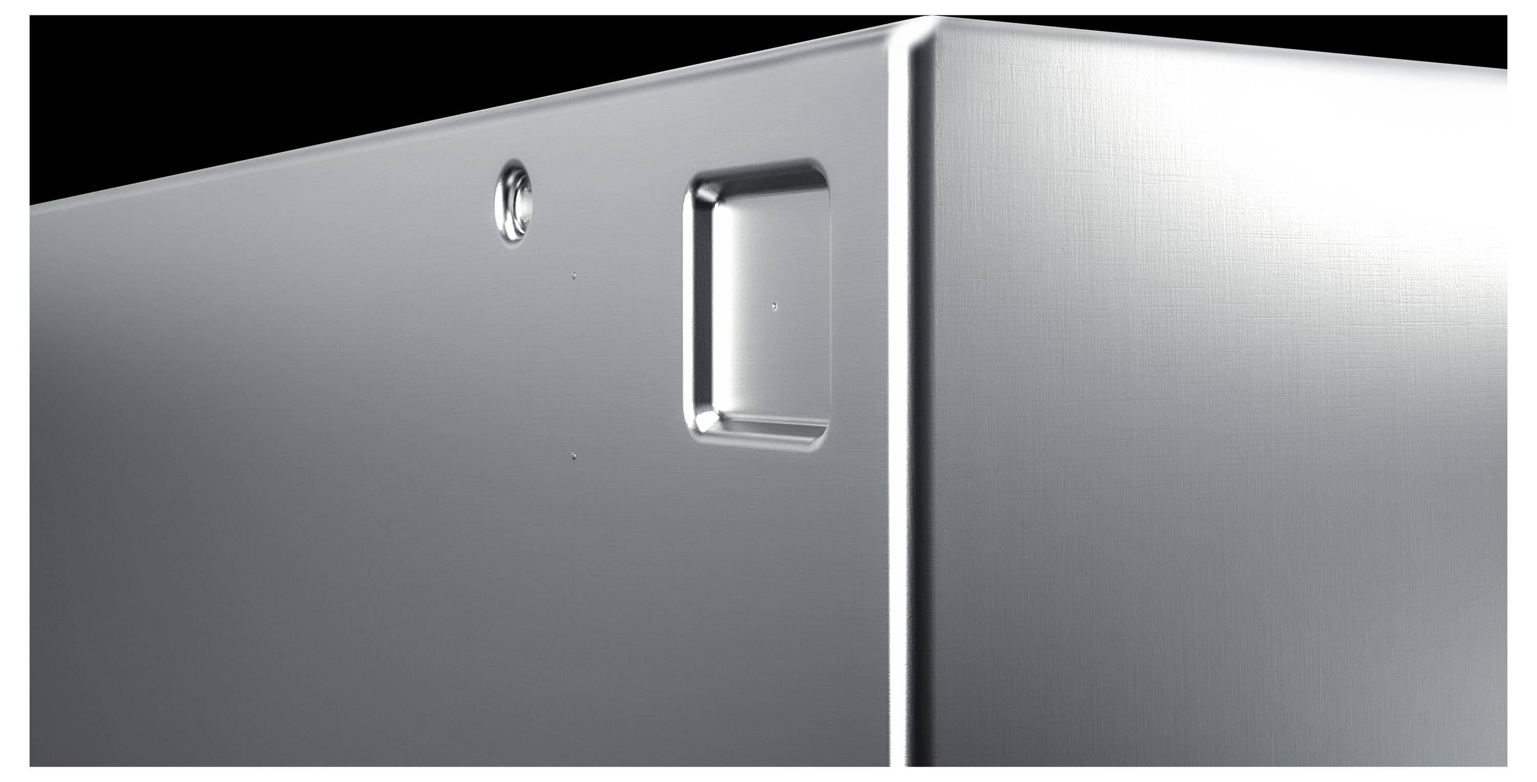 Corner of a silver-gleaming device with a view of a recessed button and a screw, showing modern electronic design.