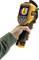 A hand is holding a thermal imaging camera, which displays a coloured thermogram on the screen. The device is yellow and black.