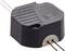 Black electronic transformer, hexagonal shape, with cable connections on one side.