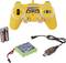 Yellow remote-controlled toy controller with two batteries, green battery, and USB charging cable.