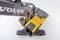A yellow excavator with a black arm and tracked chassis, viewed from above, displays 'Volvo' on the arm.