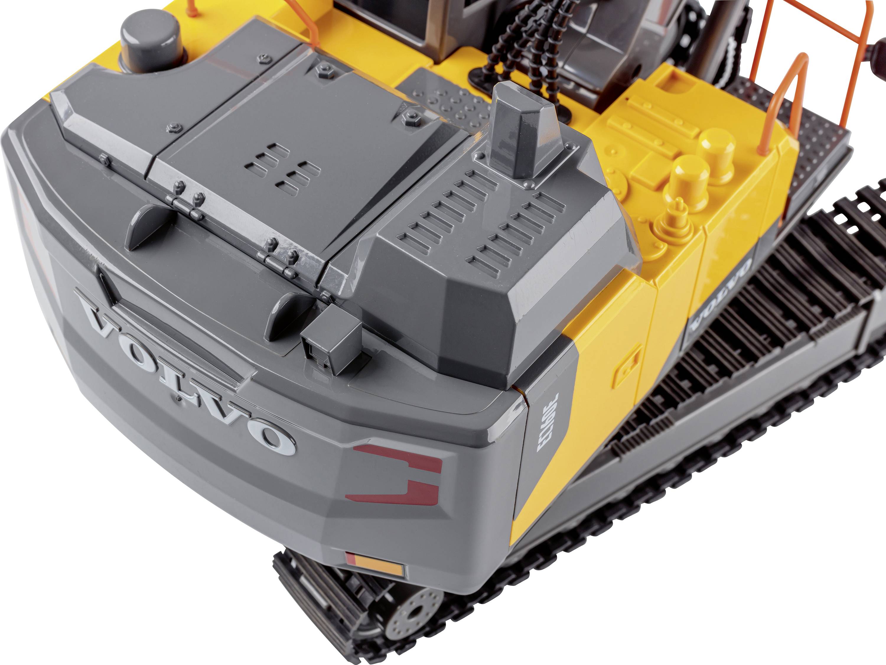 A yellow and grey toy excavator with 'Volvo' written on the back, a detailed replica with tracked undercarriage.