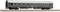 A green railway carriage with a yellow stripe and several windows is standing on a track.