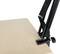 A part of a black metal microphone boom arm is attached to a light wooden board.