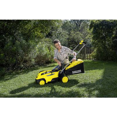 A person outdoors operating a yellow lawnmower, surrounded by green vegetation and trees.
