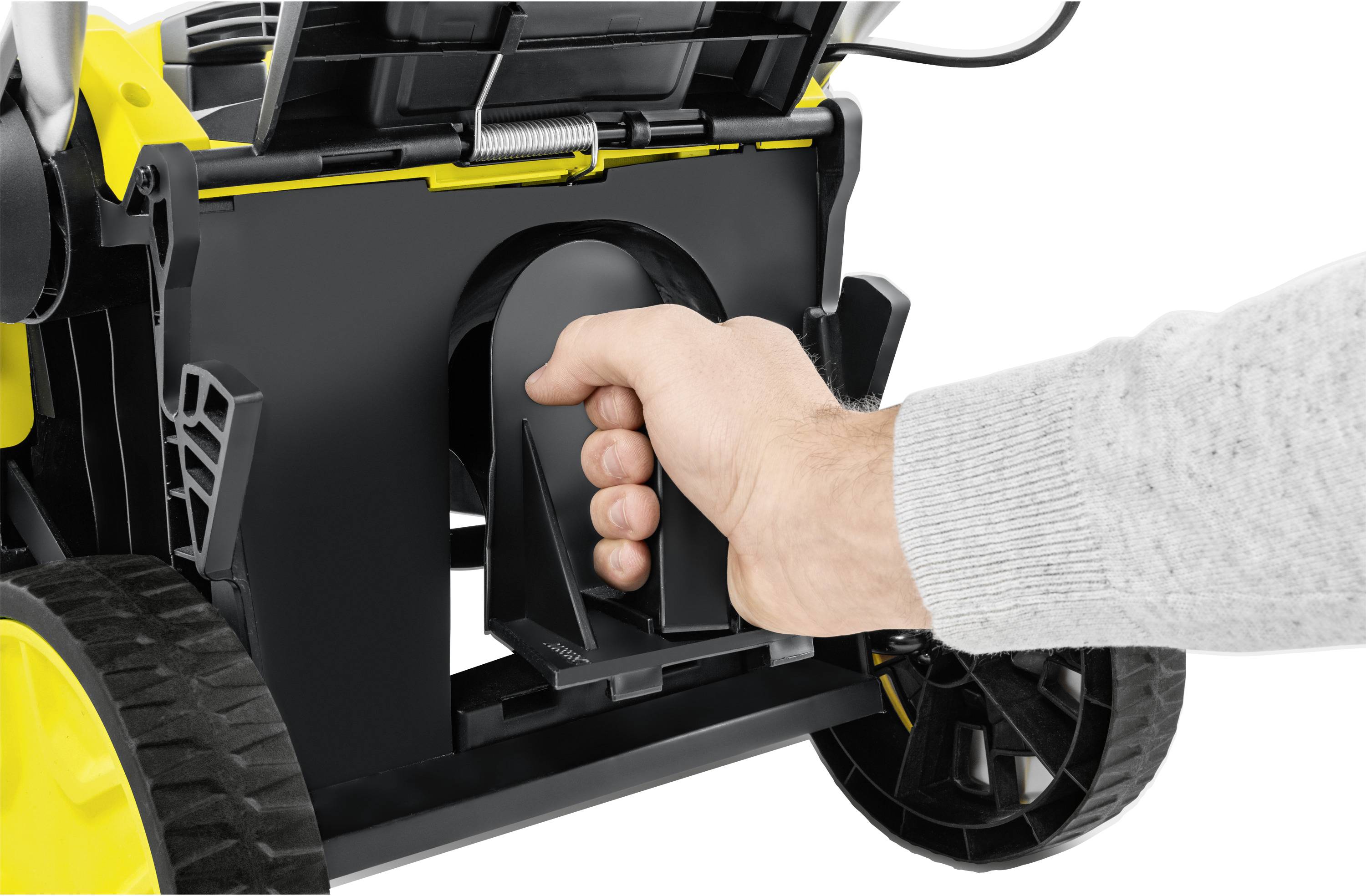 A hand removes the grass collection basket from a yellow lawnmower.