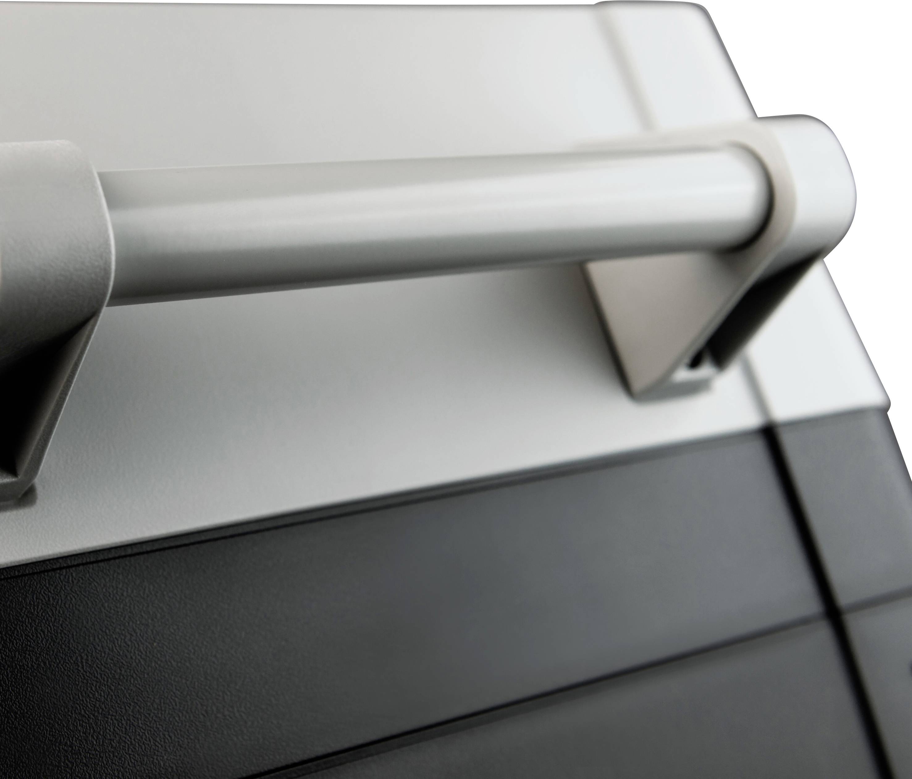 Hand gripping a modern, grey desk drawer, minimalist in design.