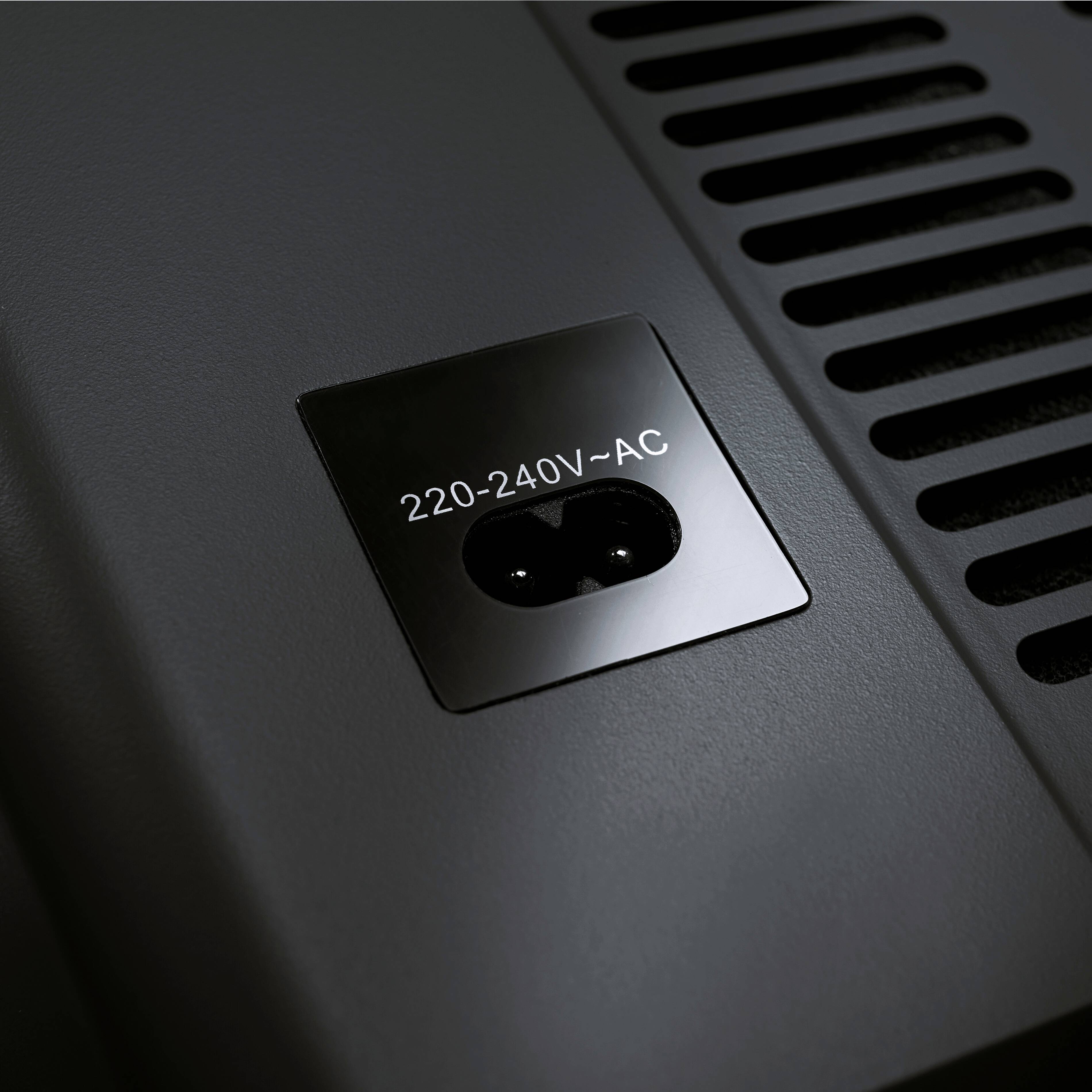 Close-up of an electrical socket with the inscription '220-240V~AC'.