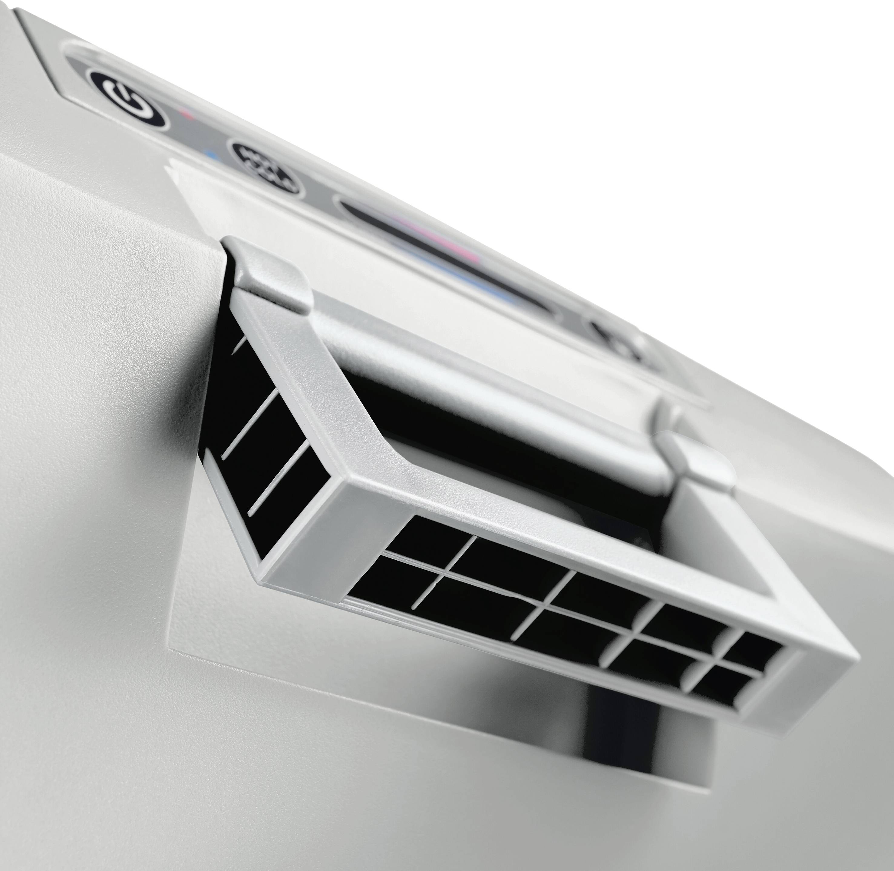 Close-up of a waste bin that appears to be part of a shredder, focusing on the ventilation grille on the side.