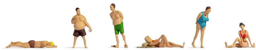 Several miniature figurines in swimwear are posing and relaxing on a white background.