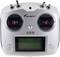 A white remote control with two control levers and an LCD display, suitable for controlling models. Switch on top for function selection.