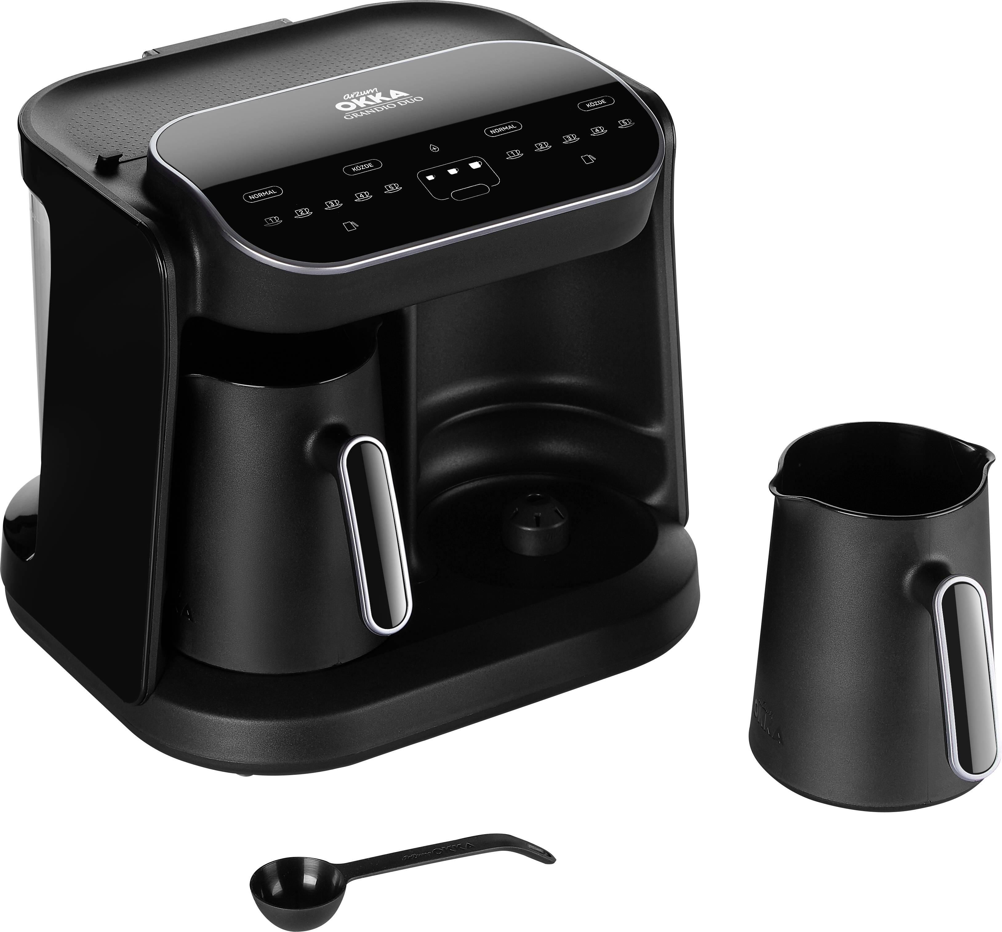 Black coffee machine with digital display, carafe and measuring spoon beside it.