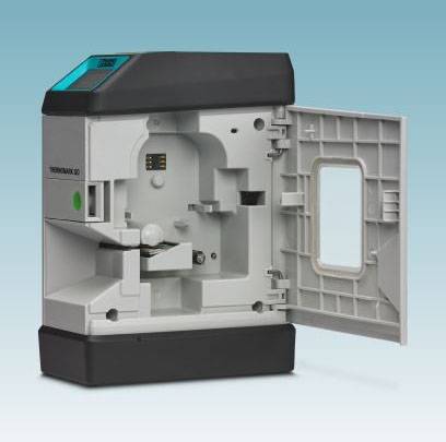 An opened medical device with a test chamber and digital display, ready for blood or urine analyses in a laboratory.