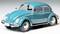 A turquoise-blue vintage Volkswagen Beetle, viewed from the side, with chrome-coloured details and classic design.