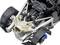 Close-up of a complex engine with visible pipes and components, mounted in a frame with matt black metal parts.