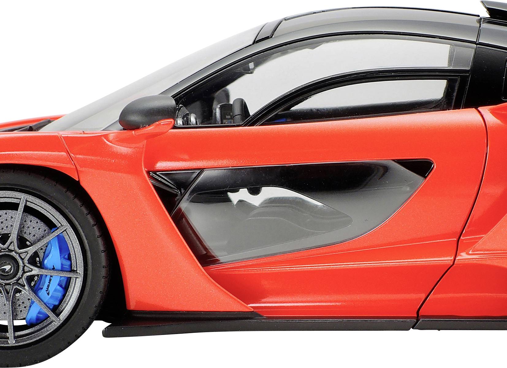 A red sports car with black and blue details, focused on the right side of the vehicle. Clear windows and sporty design visible.