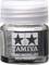 A round Tamiya paint mixing jar with a white screw lid, transparent, displaying a logo with two stars.