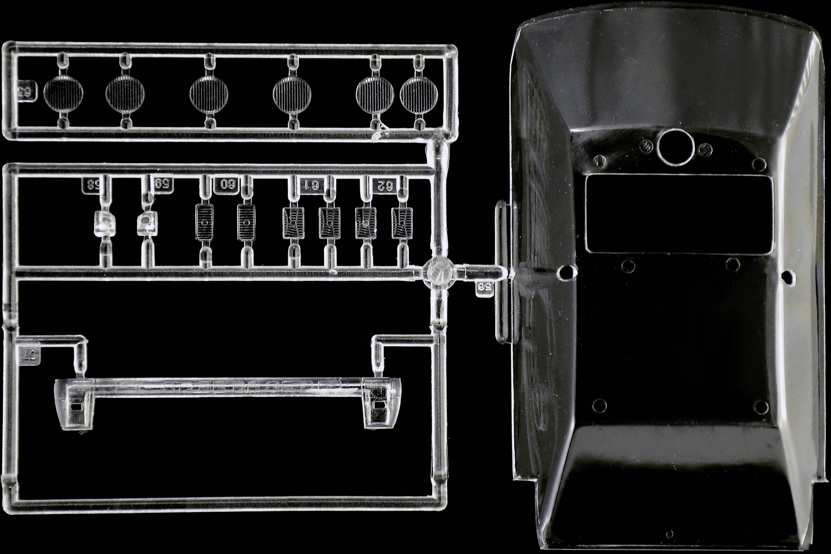 Transparent, unassembled plastic components for a model kit, arranged on a black background.