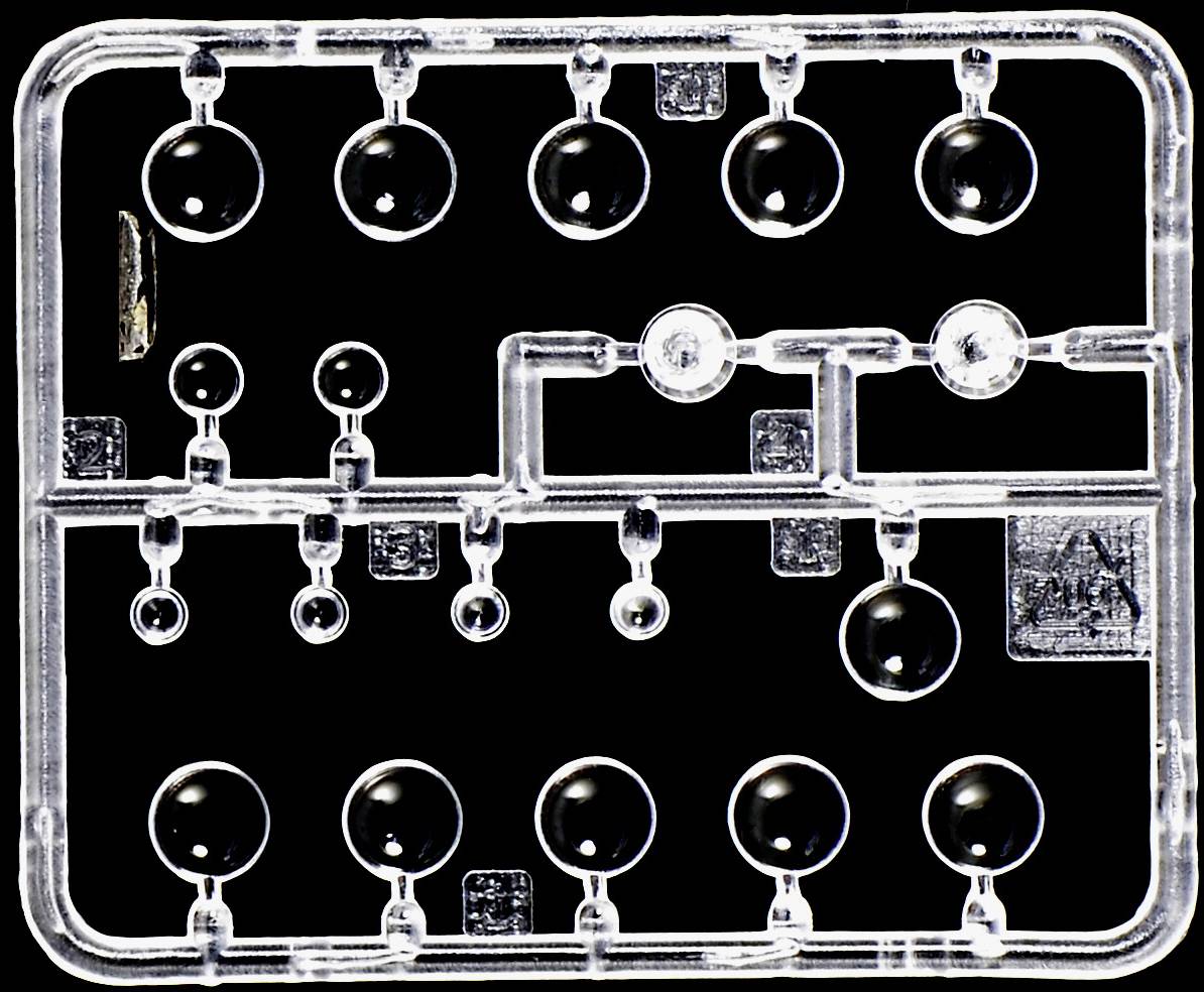 Transparent plastic frame with small, round parts evenly distributed. Model kit component against a black background.