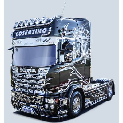 A black and white Scania lorry with distinctive decorations and the 'Cosentino' lettering on the roof.