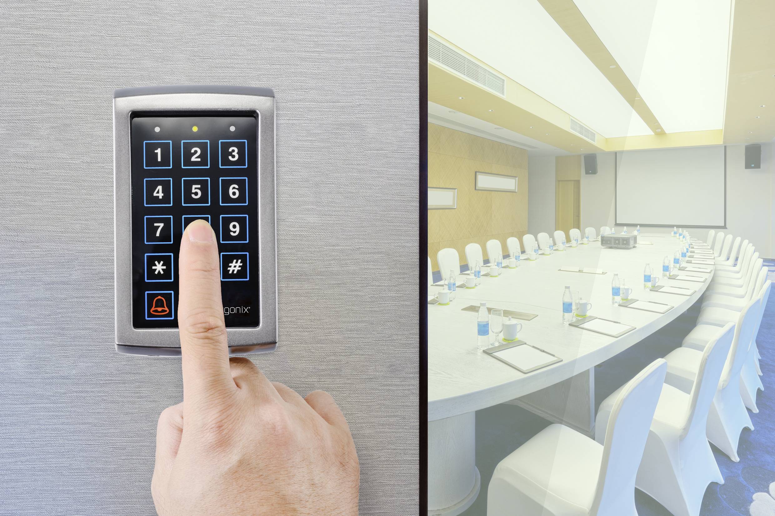 A person is pressing a button on an electronic door lock with a number pad next to an empty conference room.
