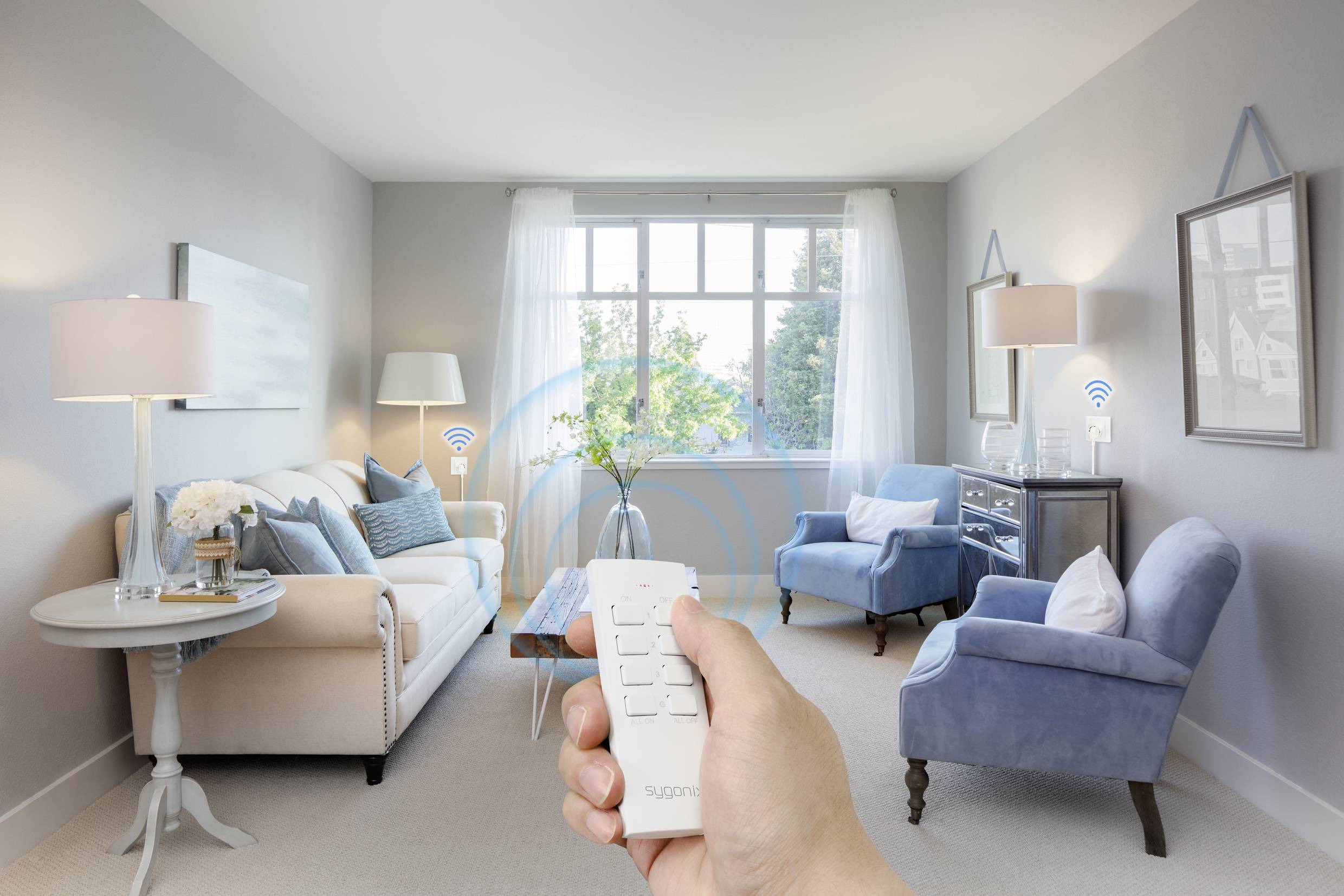 A person is holding a remote control in a modern living room. Furniture is marked with Wi-Fi symbols indicating smart control.